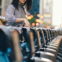 girl renting city bike from bike stand 1 1 1 scaled e1754467844253